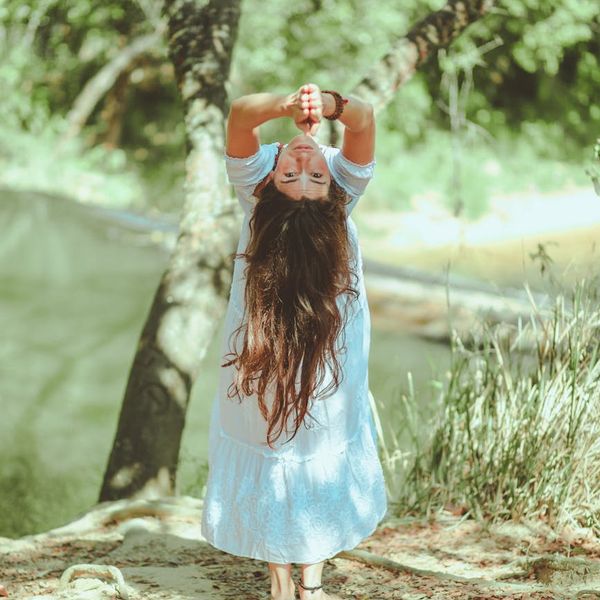 Person enjoying a moment of calm stretching in a beautiful park.
